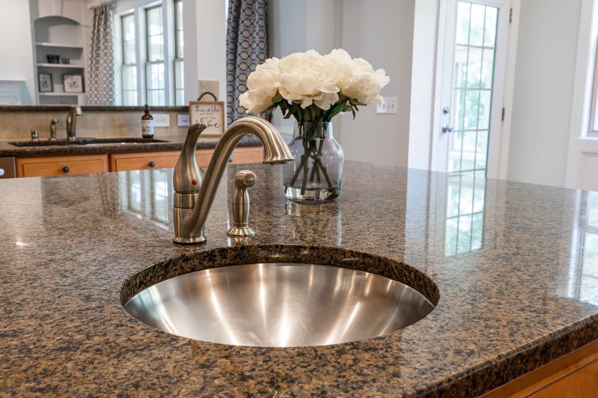 Flush-mounted push button on a kitchen countertop