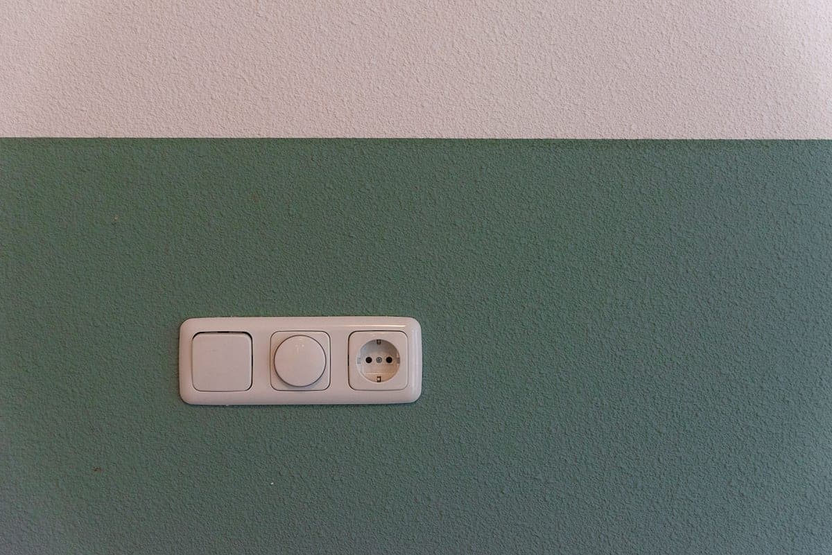Wall switch and outlet beside a kitchen counter