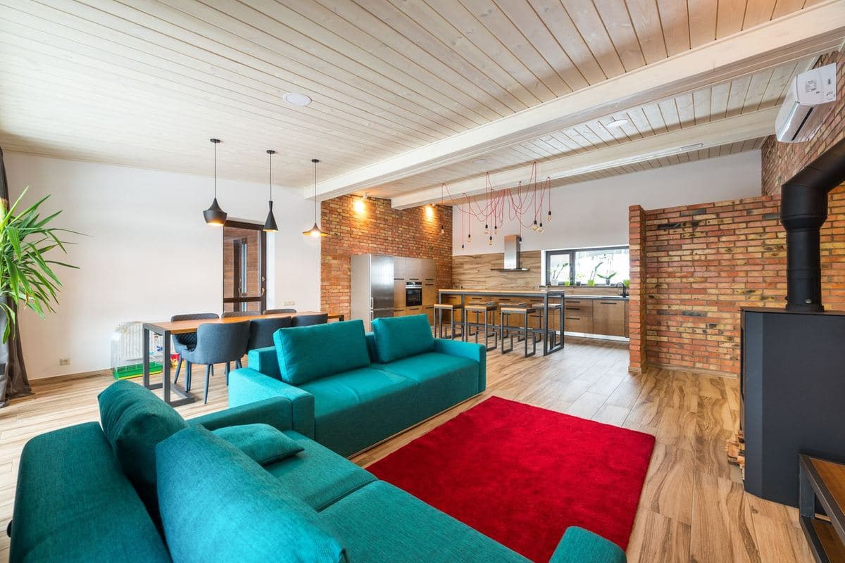 Open plan kitchen and living space with an island and seating