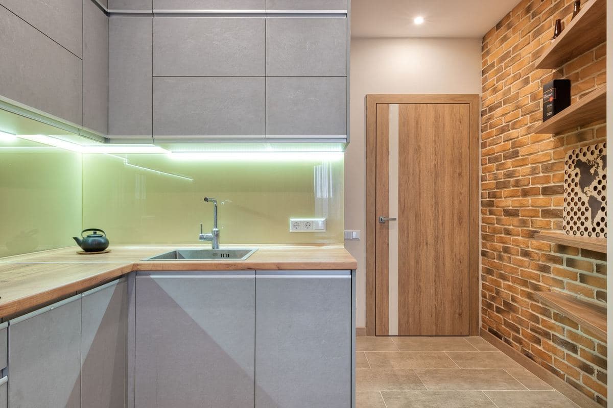 Contemporary kitchen with under-cabinet lighting above a run of cabinets