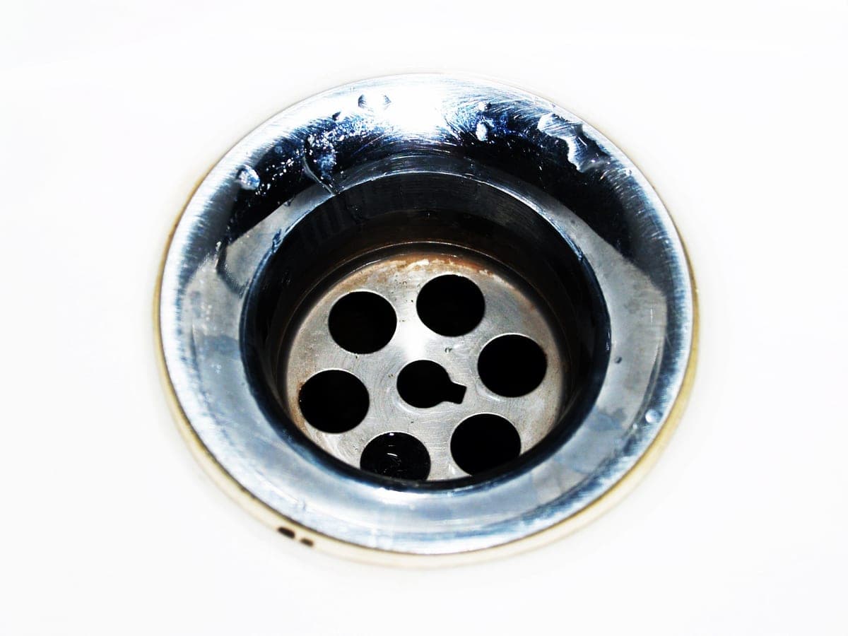Kitchen sink drain opening with the rubber splash baffle visible
