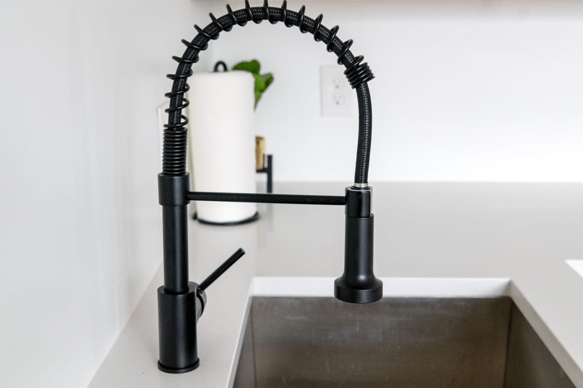 Matte black kitchen faucet above a sink
