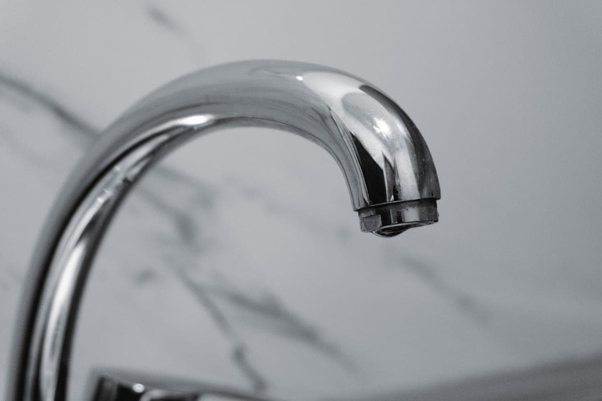 Chrome kitchen faucet detail showing the handle and spout joint