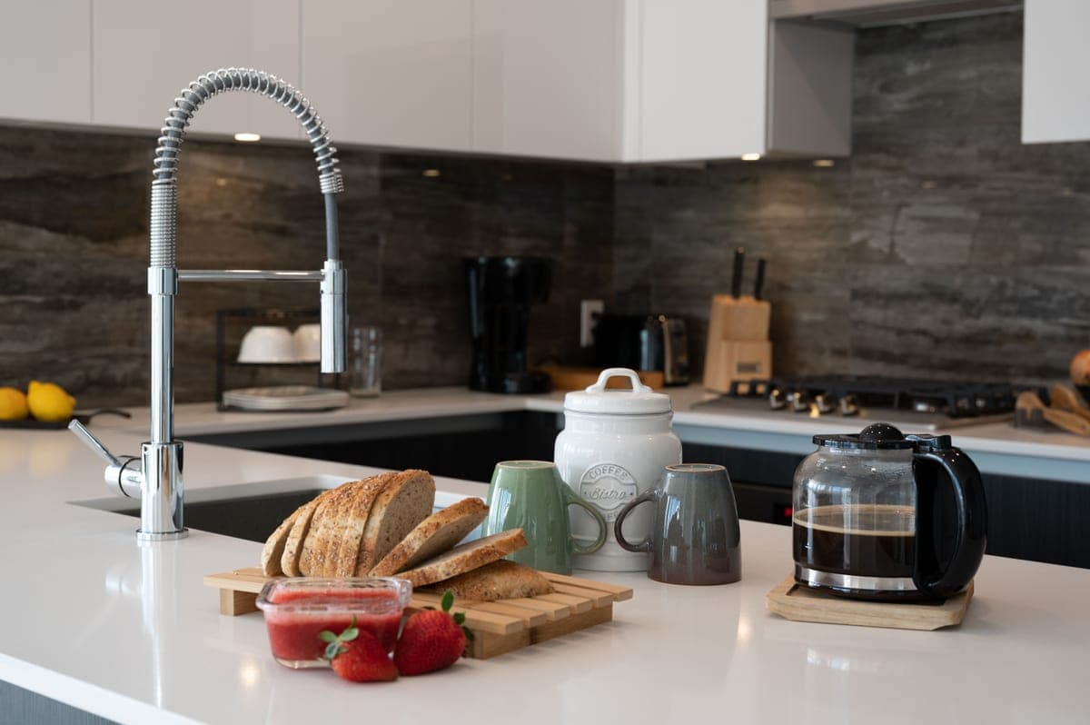 Row of kitchen faucets displayed in a showroom