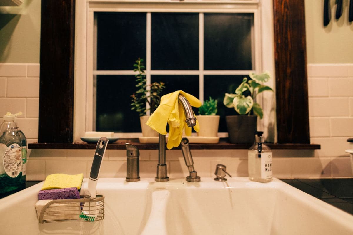 Brushed nickel pull-down kitchen faucet above a stainless sink