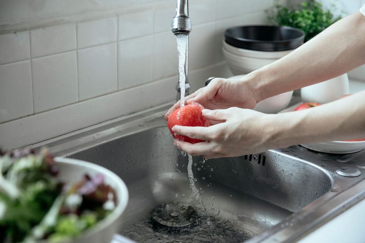Kitchen faucet base and sink deck with water running