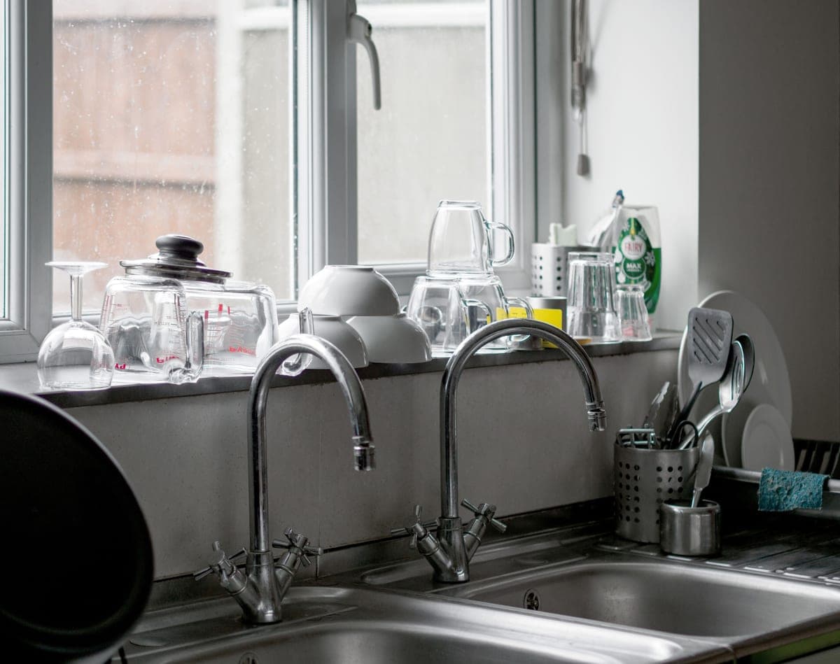 Double bowl kitchen sink with a faucet centered behind the divider