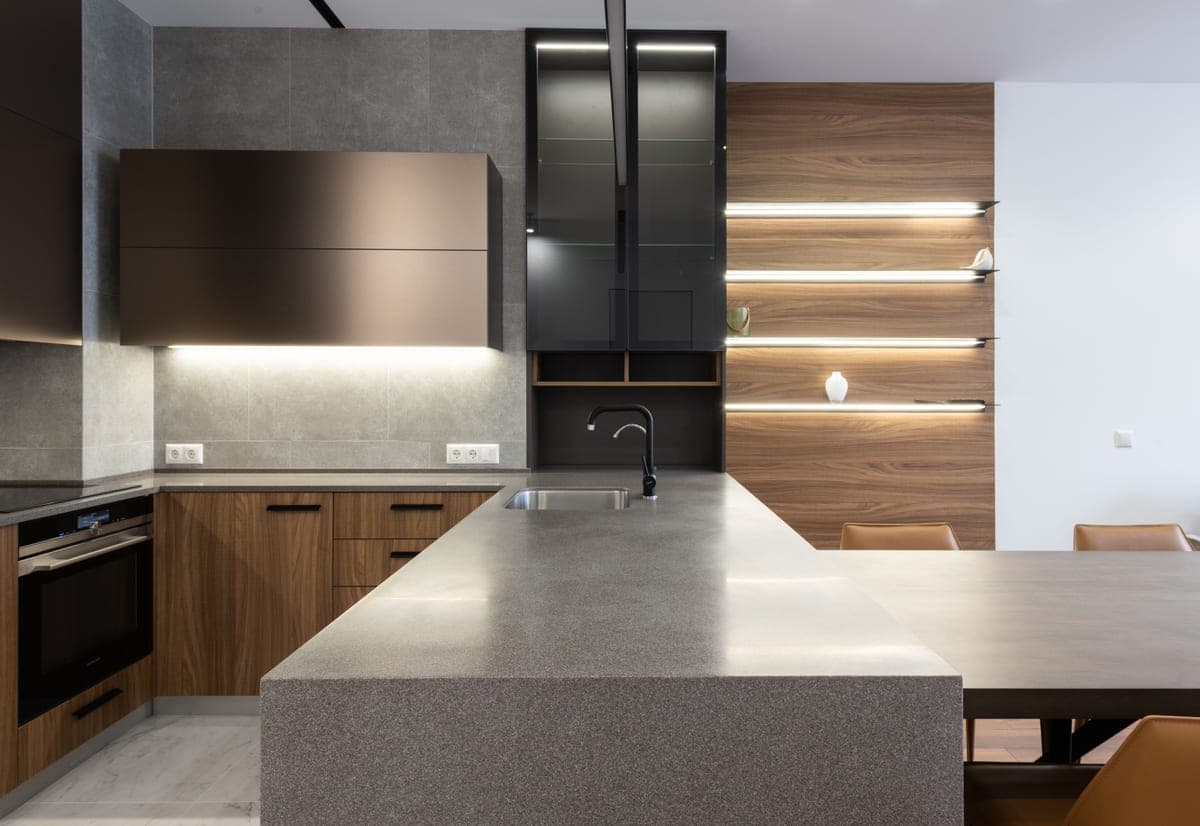 Matte black kitchen faucet against a pale kitchen wall