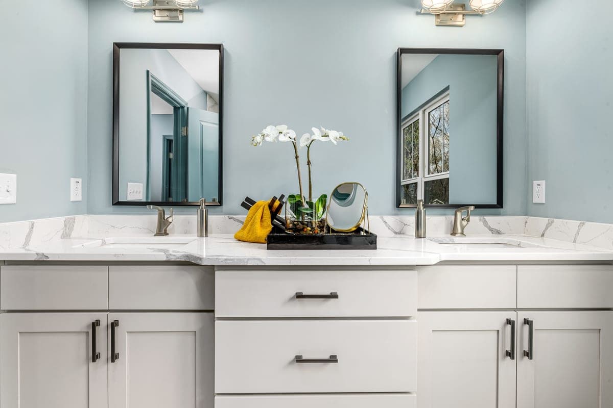 Sink deck with mounting holes visible during a faucet installation