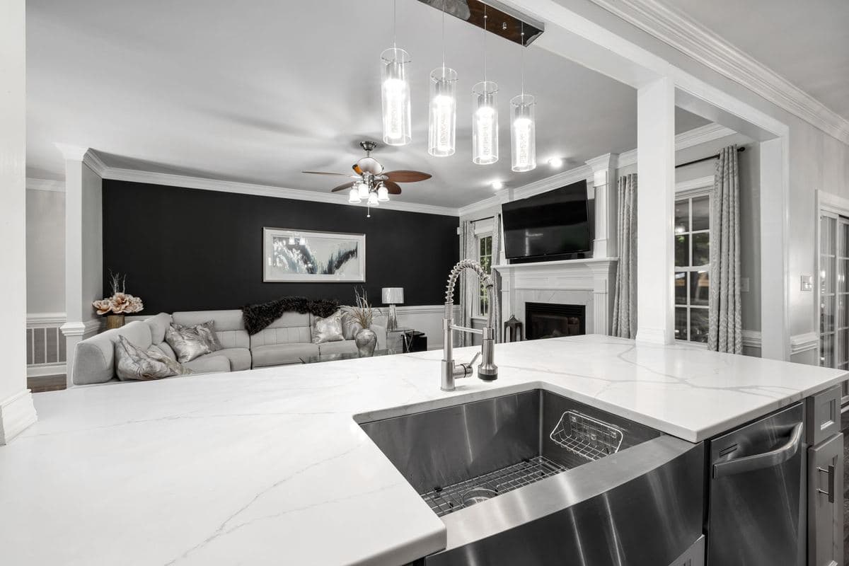 Kitchen island with a sink in an open-plan living space