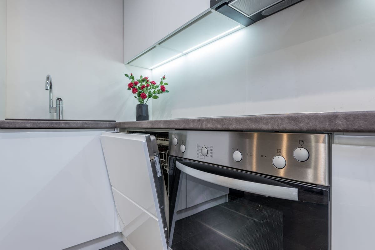 Portable dishwasher standing beside a kitchen sink