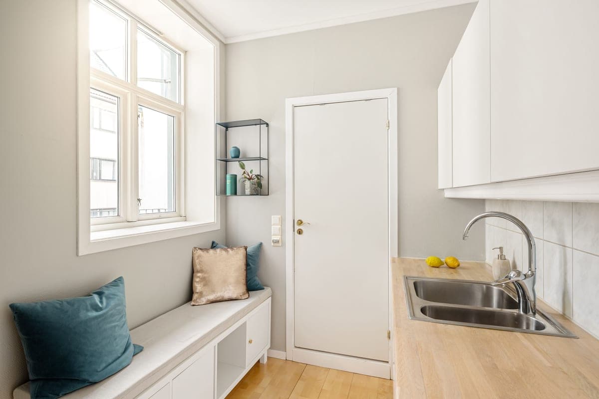 Simple kitchen sink and faucet in a plain apartment kitchen