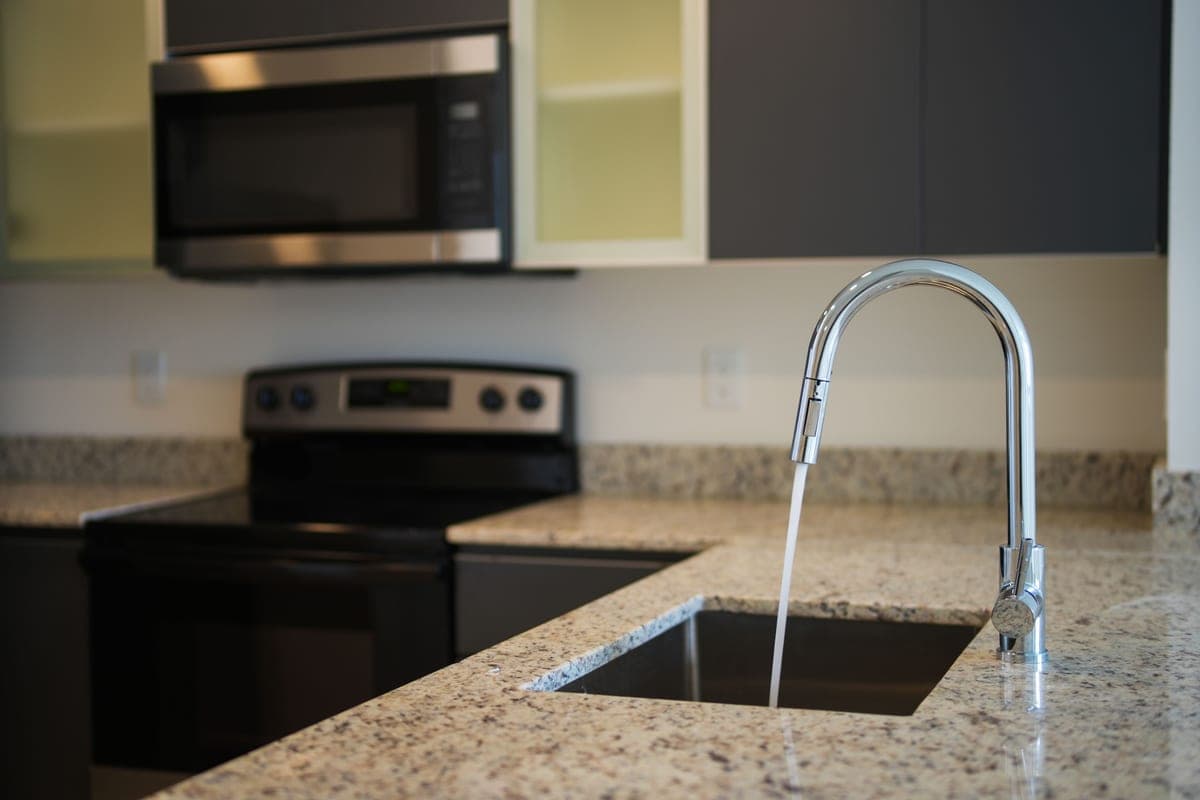 Water running from a sensor-equipped kitchen faucet