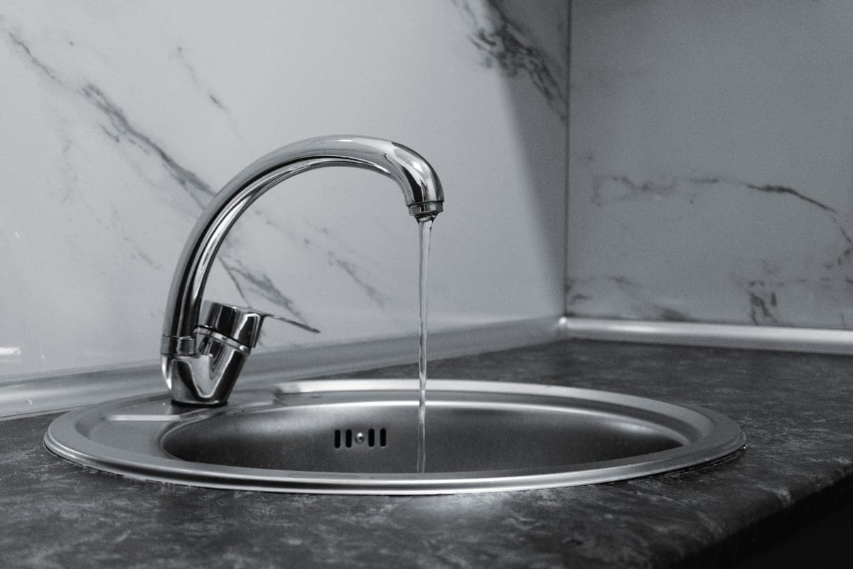 Simple stainless kitchen tap above a sink