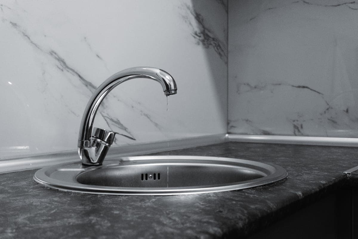 Chrome kitchen faucet over a stainless steel sink