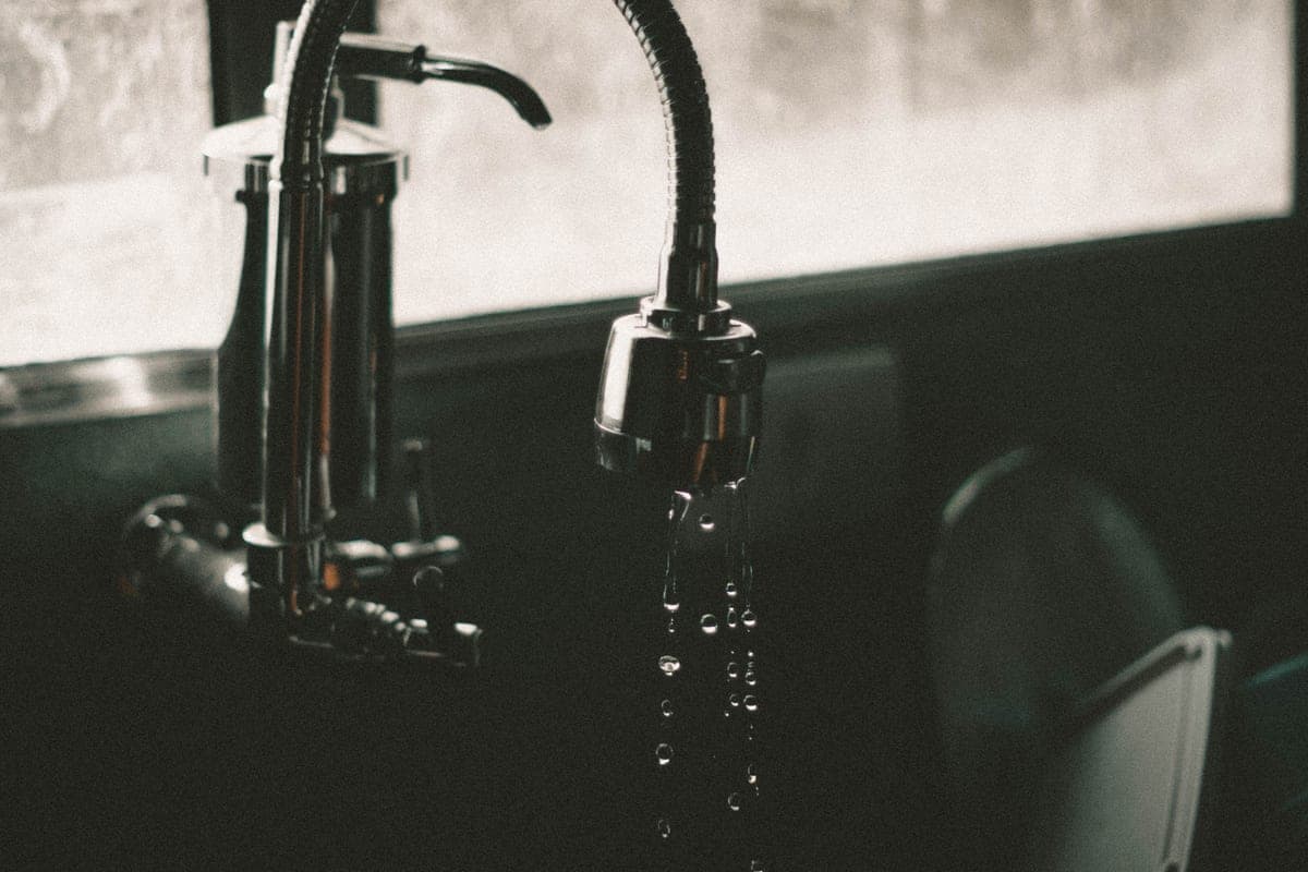 Simple chrome kitchen faucet over a stainless sink