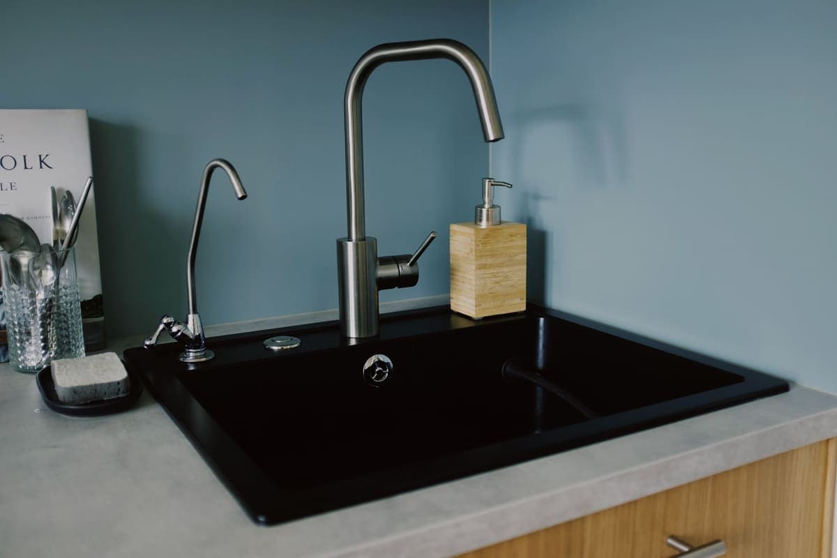 Stainless steel kitchen sink with the drain opening visible