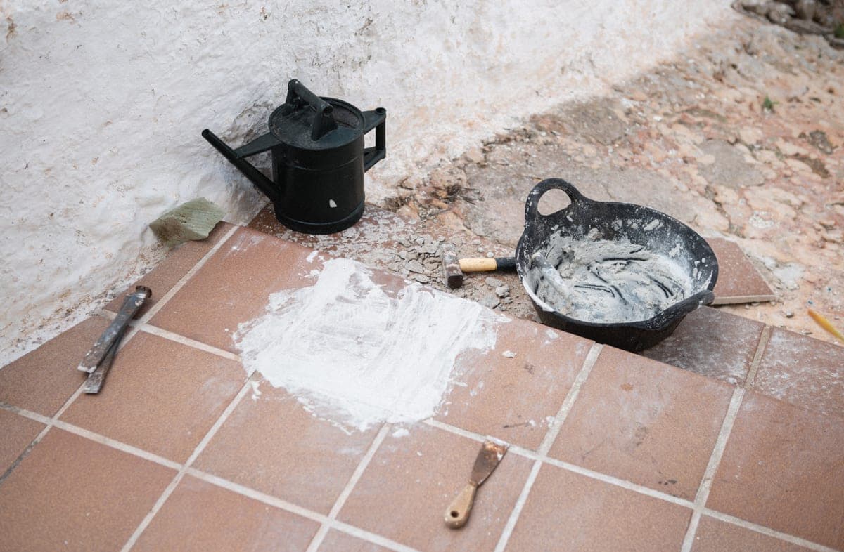 Bucket placed beneath a leaking pipe joint