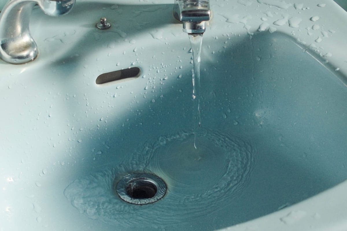 Water running into a kitchen sink drain opening