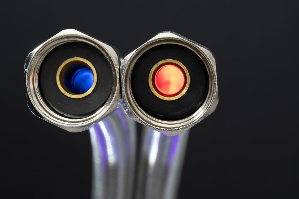 Flexible braided hose beside kitchen plumbing fittings