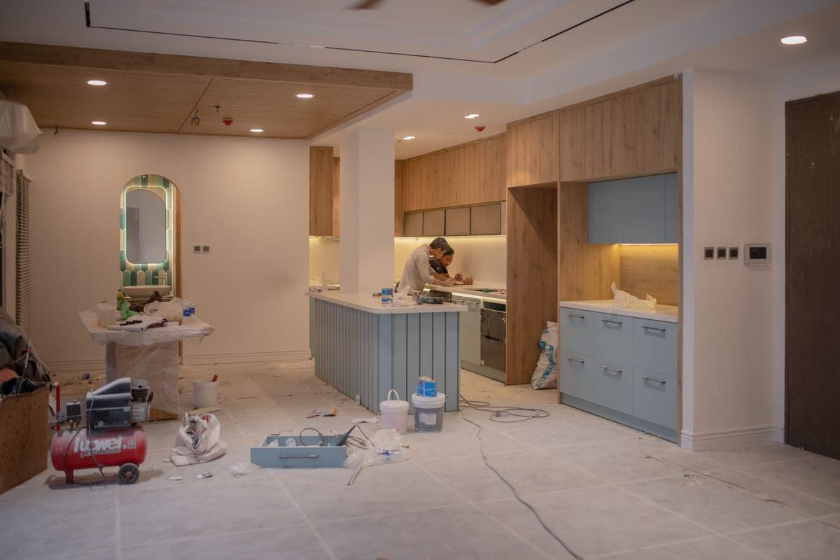 Worker fitting a countertop and sink in a kitchen