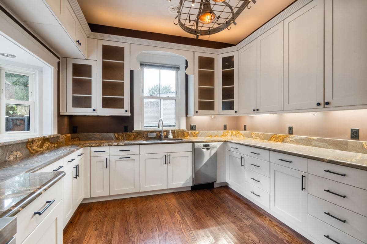 Kitchen with a wide stainless sink set into a run of base cabinets