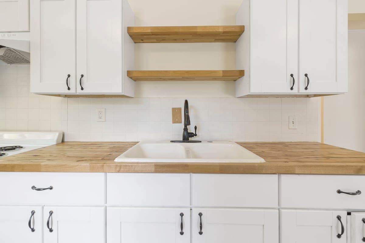 Drop-in kitchen sink with its rim sitting on the countertop surface