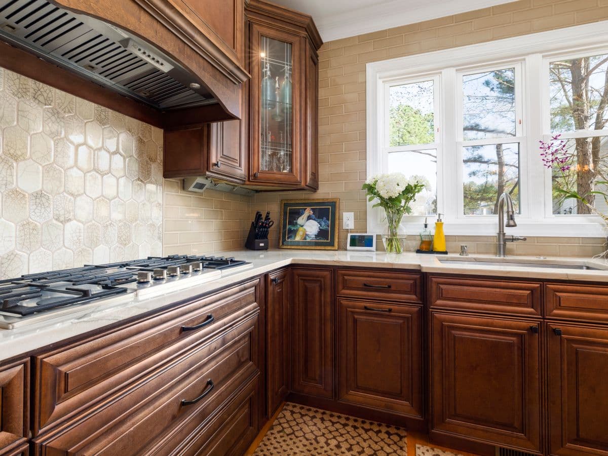 Farmhouse apron sink set into wooden kitchen cabinetry