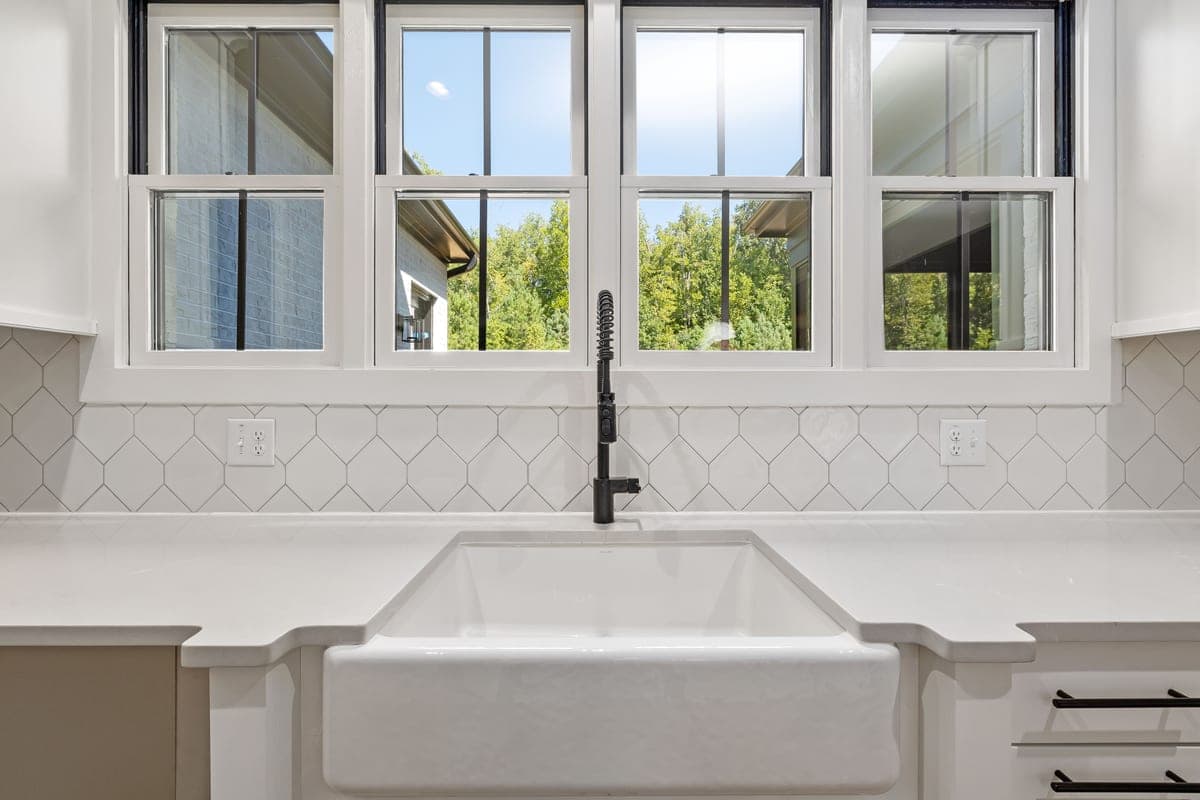 Glazed white fireclay farmhouse sink with a smooth apron front