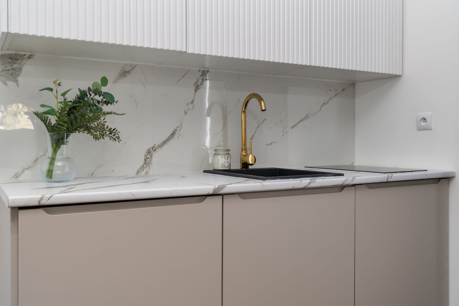 Kitchen counter run with a sink and faucet below a window