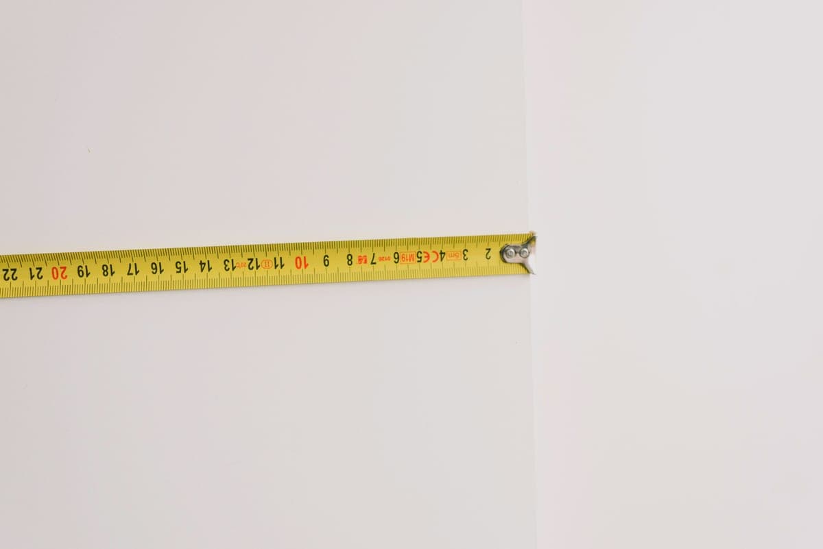 Tape measure across the opening of a kitchen base cabinet