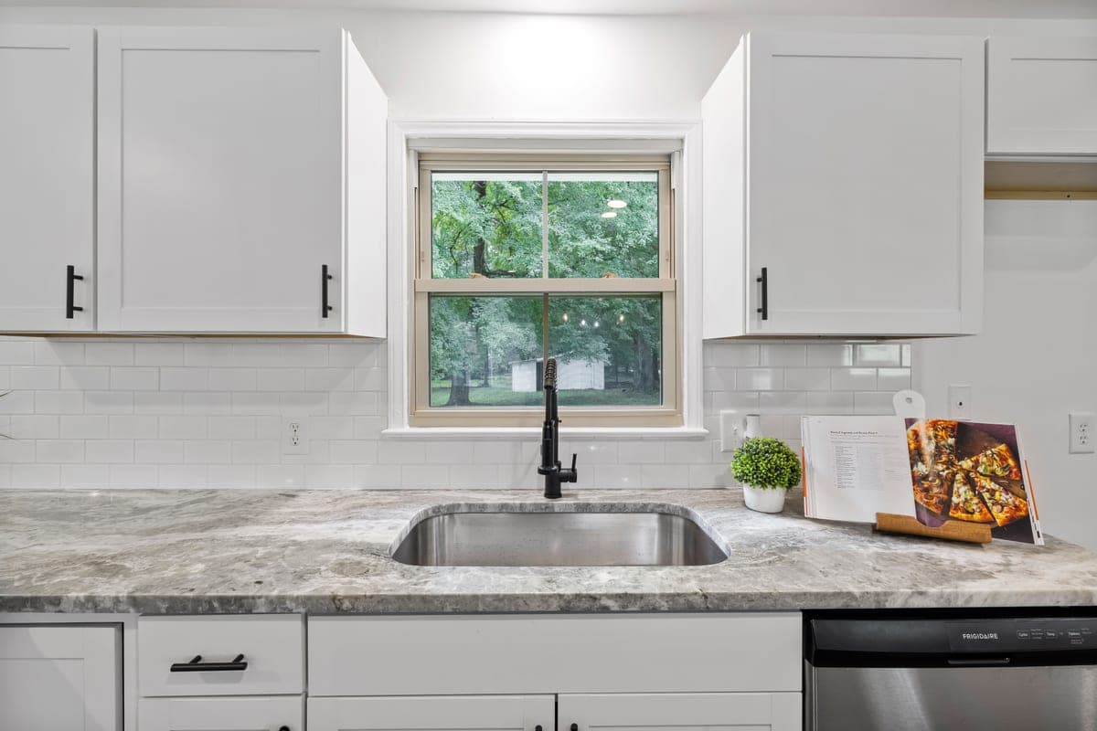 Undermount kitchen sink fitted below a stone countertop edge