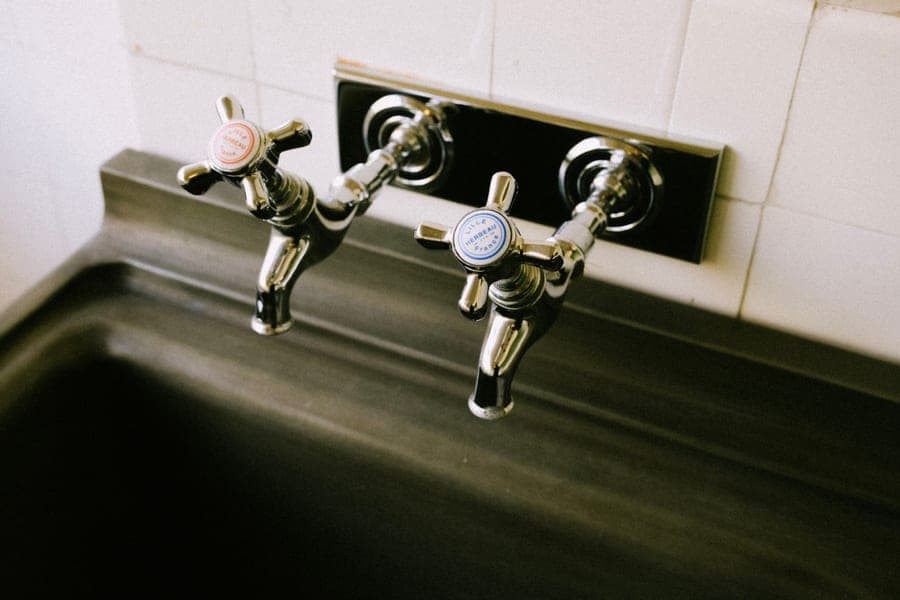 Compact chrome kitchen faucet with a low spout over a sink