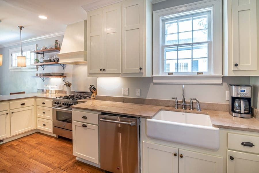 White fireclay farmhouse sink with a smooth glazed apron front
